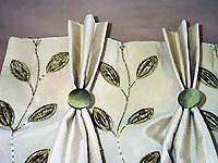 Pich pleat curtains with buttons.