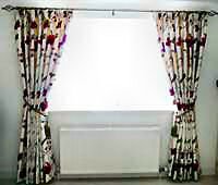 Embroidered silk interlined curtains on a metal pole.